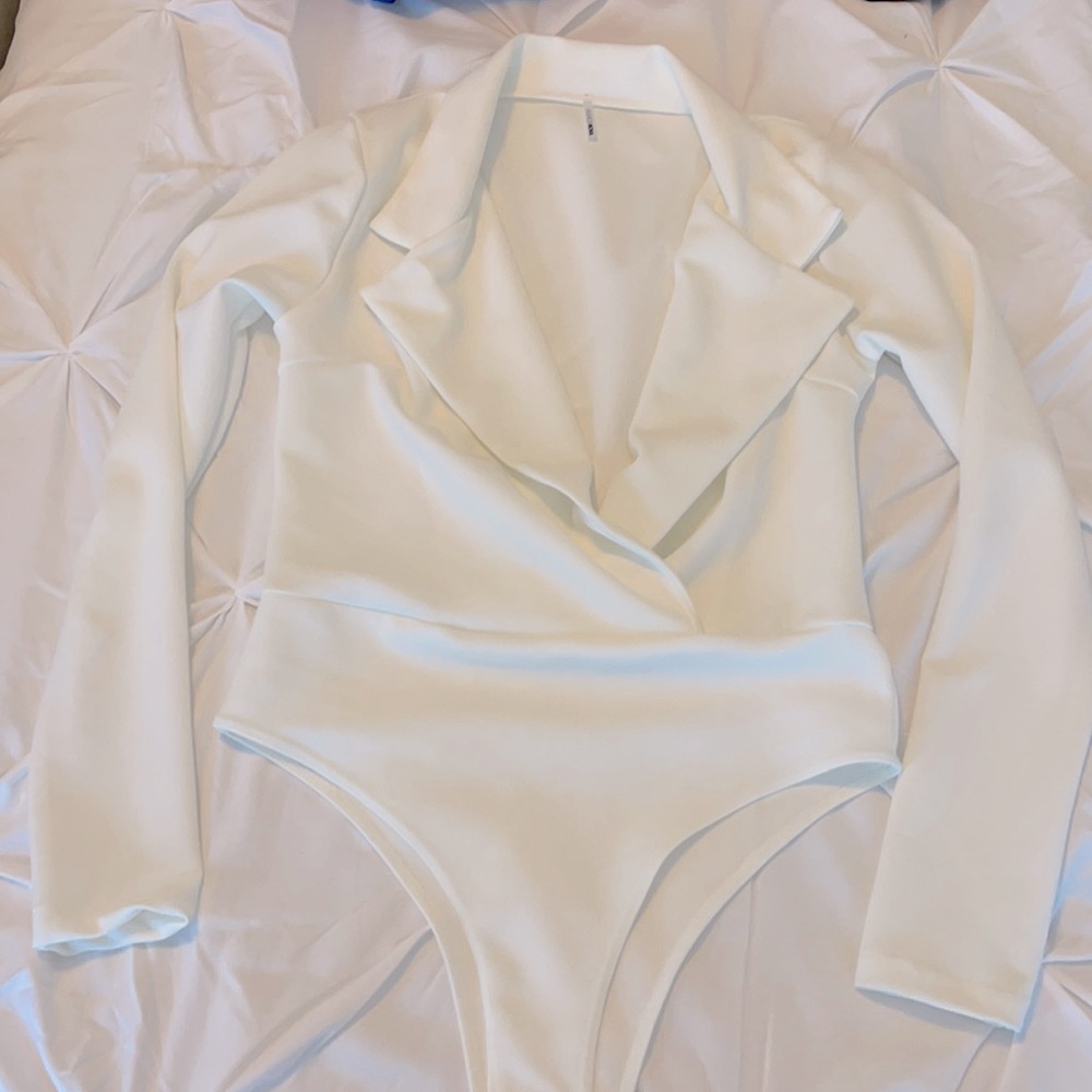 White long sleeved bodysuit. Stretchy but holds you in.